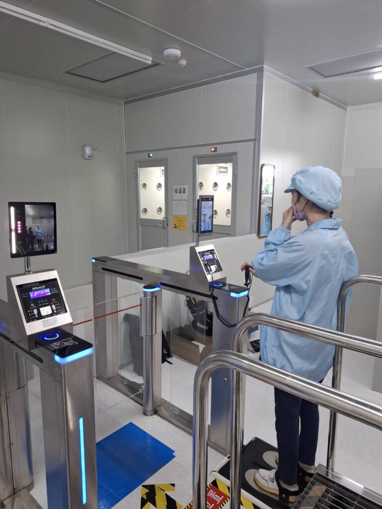 Employee passing through facial-recognition speed gate at JET OPTO